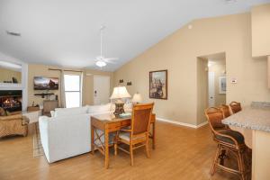 a living room with a couch and a table with chairs at Woofs and Waves by Pristine Properties Vacation Rentals in Cape San Blas