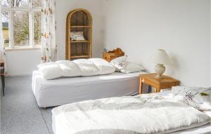 two white beds in a room with a window at Awesome Home In Trelleborg With House Sea View in Trelleborg