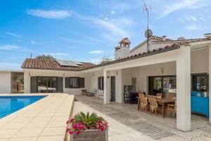 a villa with a swimming pool and a house at Villa Aurora in Llagostera