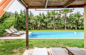 - une piscine avec chaises longues et un pavillon dans l'établissement Cozy Home In Finikia With House Sea View, à Foinikiá