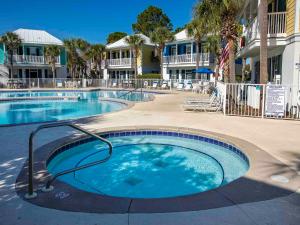 a large swimming pool in front of a resort at Bungalows at Seagrove #149 - Three Little Birds Bungalow 30A in Seagrove Beach