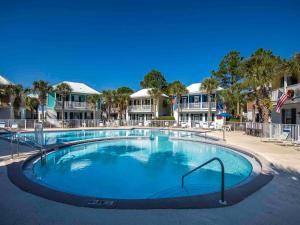 a large swimming pool in front of some houses at Bungalows at Seagrove #149 - Three Little Birds Bungalow 30A in Seagrove Beach