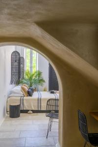 a bedroom with a bed and a table and chairs at Euphoria Chora Naxos in Naxos Chora +30 photos