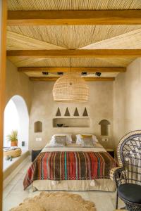 a bedroom with a bed and a wooden ceiling at Euphoria Chora Naxos in Naxos Chora