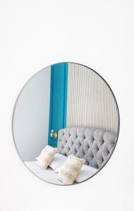 a mirror image of a bed with two pillows at Lena's Suites Bari Vecchia in Bari