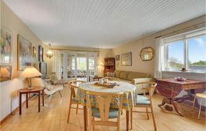 a living room with a table and chairs at Stunning Home In Tranekr With Wifi in Tranekær