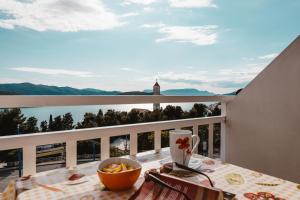 a table with a bowl of food on top of a balcony at Rooms Bačić in Neum