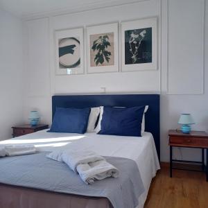 a bedroom with a blue and white bed with towels on it at Philoxenia Home in Áyios Pétros