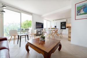 a living room with a coffee table and a kitchen at Superbe T3 de 70m2 face à la mer in Royan
