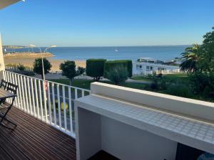 a balcony with a view of the beach at Superbe T3 de 70m2 face à la mer in Royan