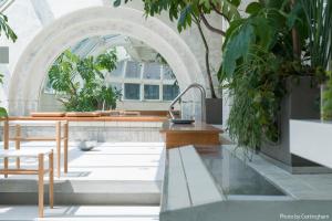 a greenhouse with a table and potted plants at KIRO Hiroshima by THE SHARE HOTELS in Hiroshima