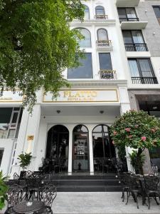 a building with tables and chairs in front of a store at HOME by FLATTO APARTMENT in Ho Chi Minh City