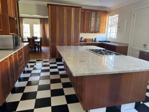 a kitchen with a black and white checkered floor at Thula Guest Farm in Clarens