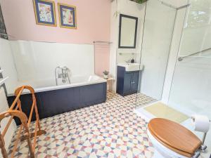 a bathroom with a tub and a toilet and a sink at Foxhills of Shanklin in Shanklin