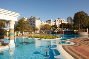 a swimming pool in a resort with buildings in the background at Dreams Sunny Beach Resort and Spa - Premium All Inclusive in Sunny Beach