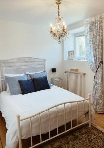a bedroom with a large white bed with blue pillows at Ar Maen Gite et Chambres d'hotes in Lanvollon