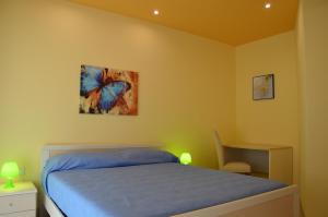 a bedroom with a bed and a butterfly painting on the wall at La Stella di Gallipoli in Gallipoli