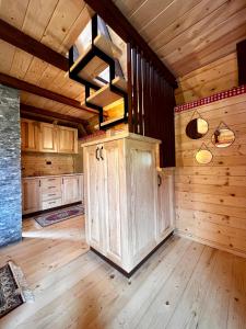 a large kitchen with wooden walls and wooden flooring at Etno Idila D&D in Žabljak