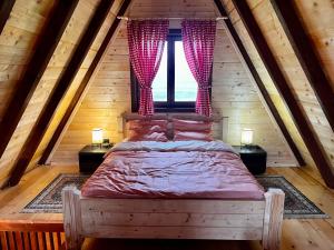 a bedroom with a large bed in a attic at Etno Idila D&D in Žabljak