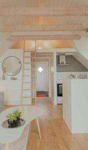 a living room with a table and a kitchen at Unique boathouse by the foreshore / Sea view in Strendur