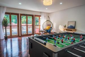 a living room with a large pool table at Tropical Bliss Luxe 5BR 30Pax Private Pool Villa KL by Verano in Kuala Lumpur