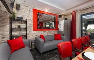 a living room with a gray couch and red pillows at Nice Home In Vantacici With Wifi in Porat