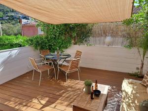 a patio with a table and chairs on a deck at T2 avec terrasse à La Fossette in Le Lavandou