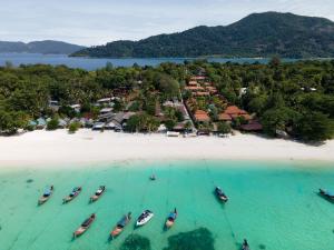 an aerial view of a beach with boats in the water at Chareena Beachside in Ko Lipe