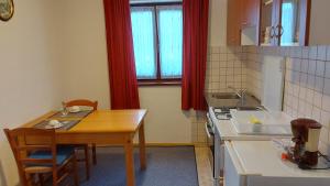 a small kitchen with a wooden table and a sink at house anna in Rastovača