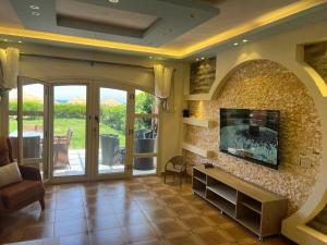 a living room with a fireplace and a tv at Villa Front Beach First row family only in Ain Sokhna