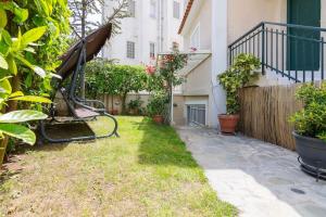a backyard with a swing and a fence at Appartment in Nea Erithrea in Athens