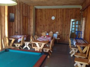 a pool table in a room with wooden walls at Club Torony Hotel in Torony