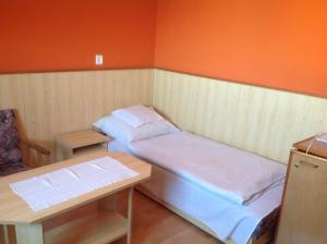 a small room with two beds and a table at Club Torony Hotel in Torony