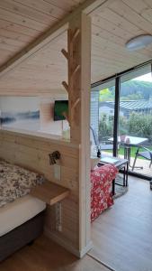 Habitación con cama y lavamanos en una cabaña en Sauerland-Tinyworld - Ihr Tiny Ferienhaus im Sauerland am Diemelsee en Diemelsee