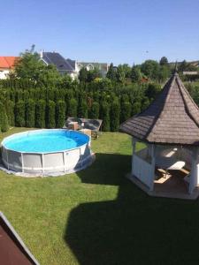 a backyard with a swimming pool and a gazebo at Apartment Gyenesdias 3 in Gyenesdiás