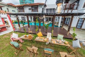 an overhead view of a patio with chairs and a pool at Tropical Bliss Luxe 5BR 30Pax Private Pool Villa KL by Verano in Kuala Lumpur