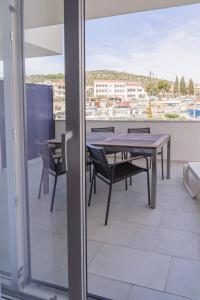 a table and chairs on a balcony with a view at Blue Marina Apartments in Marina +107 photos