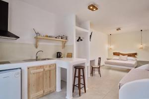 a kitchen with a sink and a counter top at Casa Philippi Suites in Mýkonos City