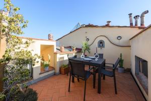 a small balcony with a table and chairs on a patio at Apartments Florence- Faenza Terrace in Florence