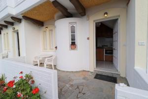 a front door of a house with a table and chairs at Villa Aristea in Kalo Chorio