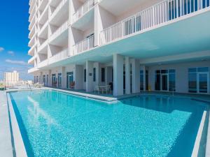 a swimming pool in front of a building at Windemere #1104 in Perdido Key
