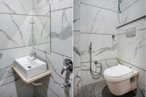 a bathroom with a toilet and a sink at FabHotel Coral in Indore