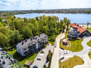 an aerial view of a building next to a lake at Apartament nad jeziorem Drwęckim Turystyczna # 17 in Ostróda