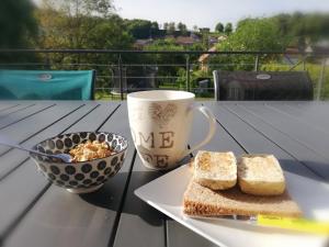 una mesa con un plato de pan y una taza de café en chez Zoléan, 