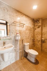 a bathroom with a toilet and a sink at Chaca Beach House in Da Nang