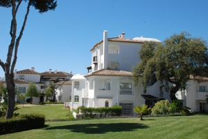 a large white house with trees and grass at Casa Elviria Del Sol in Marbella