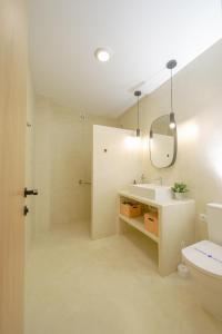 a bathroom with a sink and a toilet at Moott Homes Suites Villa Costacabana in Almería