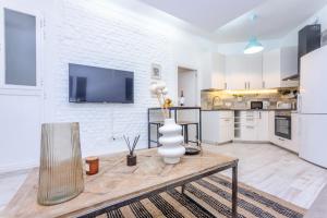 uma sala de estar com uma mesa e uma cozinha em For Your Rentals Título Moderno y elegante apartamento en barrio Ibiza MEN30 em Madri