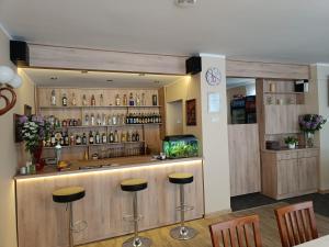 a bar in a restaurant with stools at Hotel Wanda in Kętrzyn
