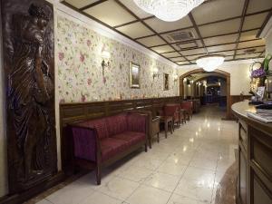 a restaurant with a row of chairs and floral wallpaper at Arlington Hotel O'Connell Bridge in Dublin